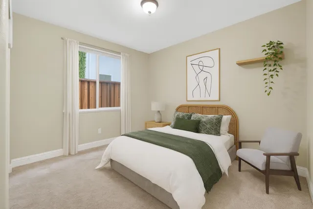 a bedroom with a bed and a lamp