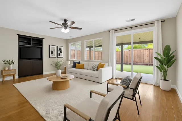 a living room with furniture potted plant and a window