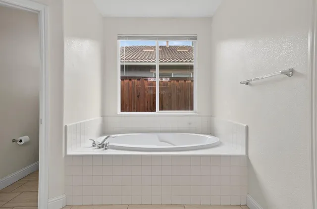 a bathroom with a tub and a window