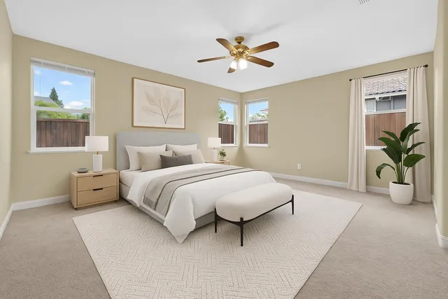 a bedroom with a bed and painting on the wall