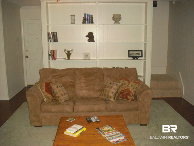 6156 Brandy Run Road South Mobile, AL 36608 - Photo 8 of 16 Basement Den features Custom Built-ins, 15-light door & windows that view the Screened-in porch. Access to 3 Bedrooms, Bath, Laundry Room and Entry to spacious Double Garage & Staircase storage.