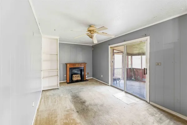 a view of an empty room with a fireplace