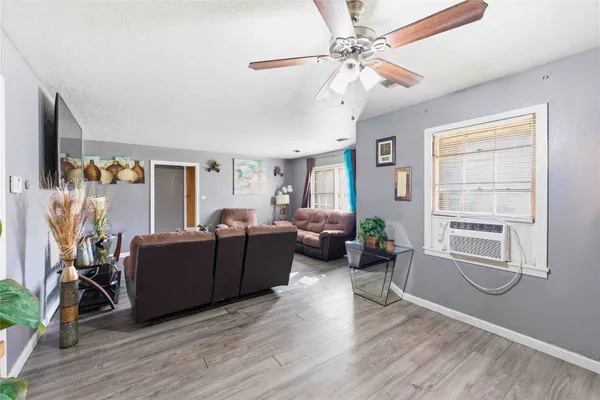 a living room with furniture and wooden floor