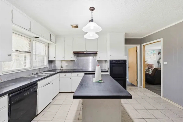 a kitchen with stainless steel appliances granite countertop a sink a stove and refrigerator