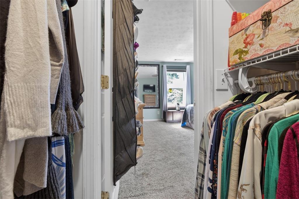 3771 Castleberry Road Cumming, GA 30040 - Photo 32 of 69 a view of walk in closet with clothes and shoes