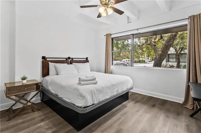 a bedroom with a large bed and a large window