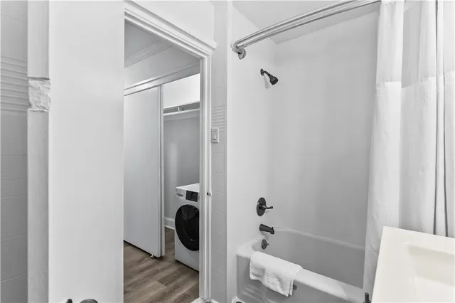 a bathroom with a tub and a shower