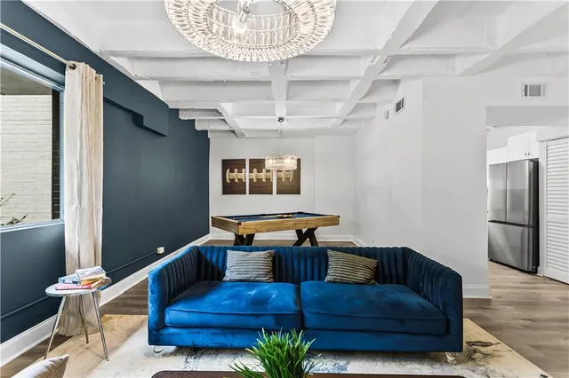 a living room with furniture and a chandelier
