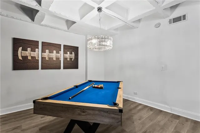 a room with pool table and windows