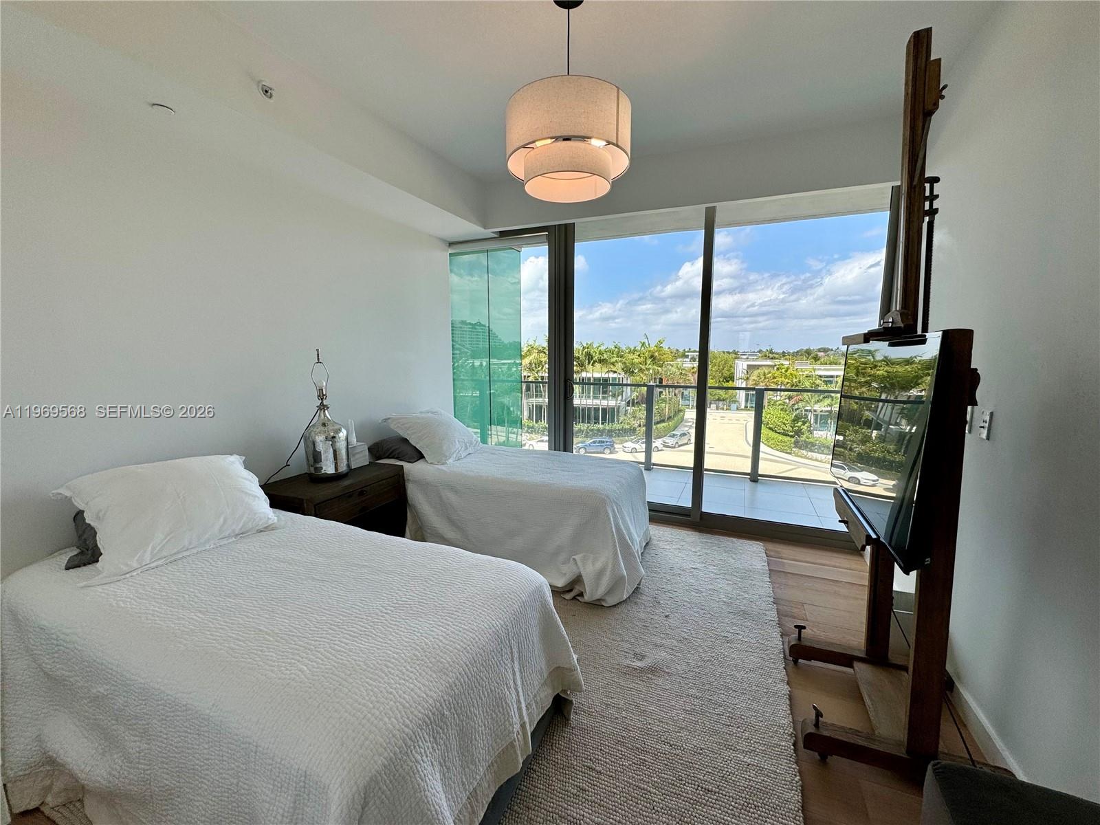 350 Ocean Drive, Unit 406N Key Biscayne, FL 33149 - Photo 33 of 41 a bedroom with two large bed and a large window