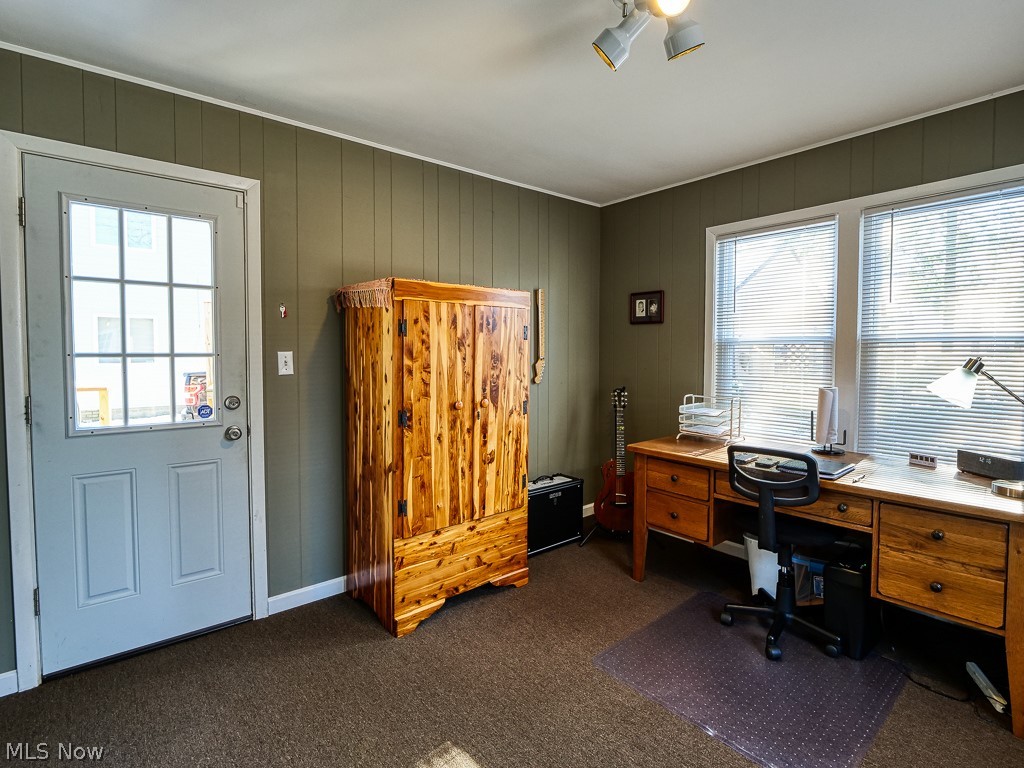 3844 Severn Road Cleveland Heights, OH 44118 - Photo 15 of 35 Exit to the back yard deck from this room, wood panel wall covering, carpeted floor, wall to wall windows.