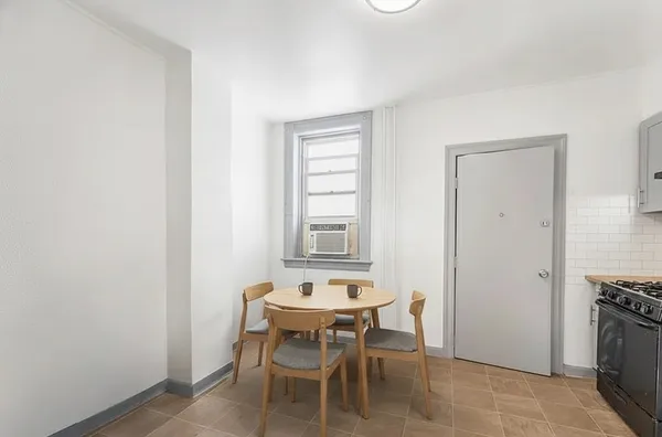 a view of a dining room with furniture and window