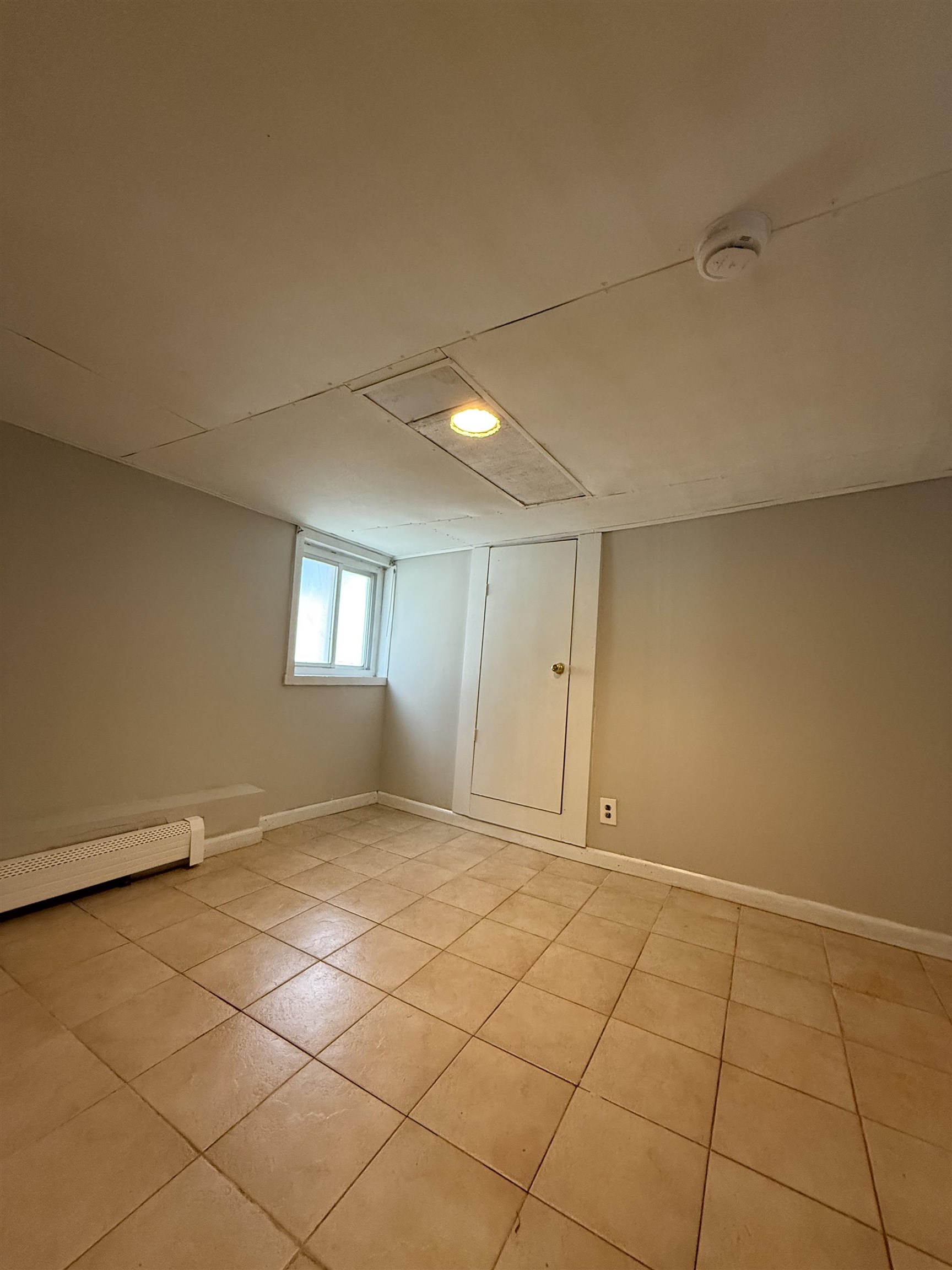 1430 44th Street, Unit 1 North Bergen, NJ 07047 - Photo 7 of 9 a view of an empty room and a window