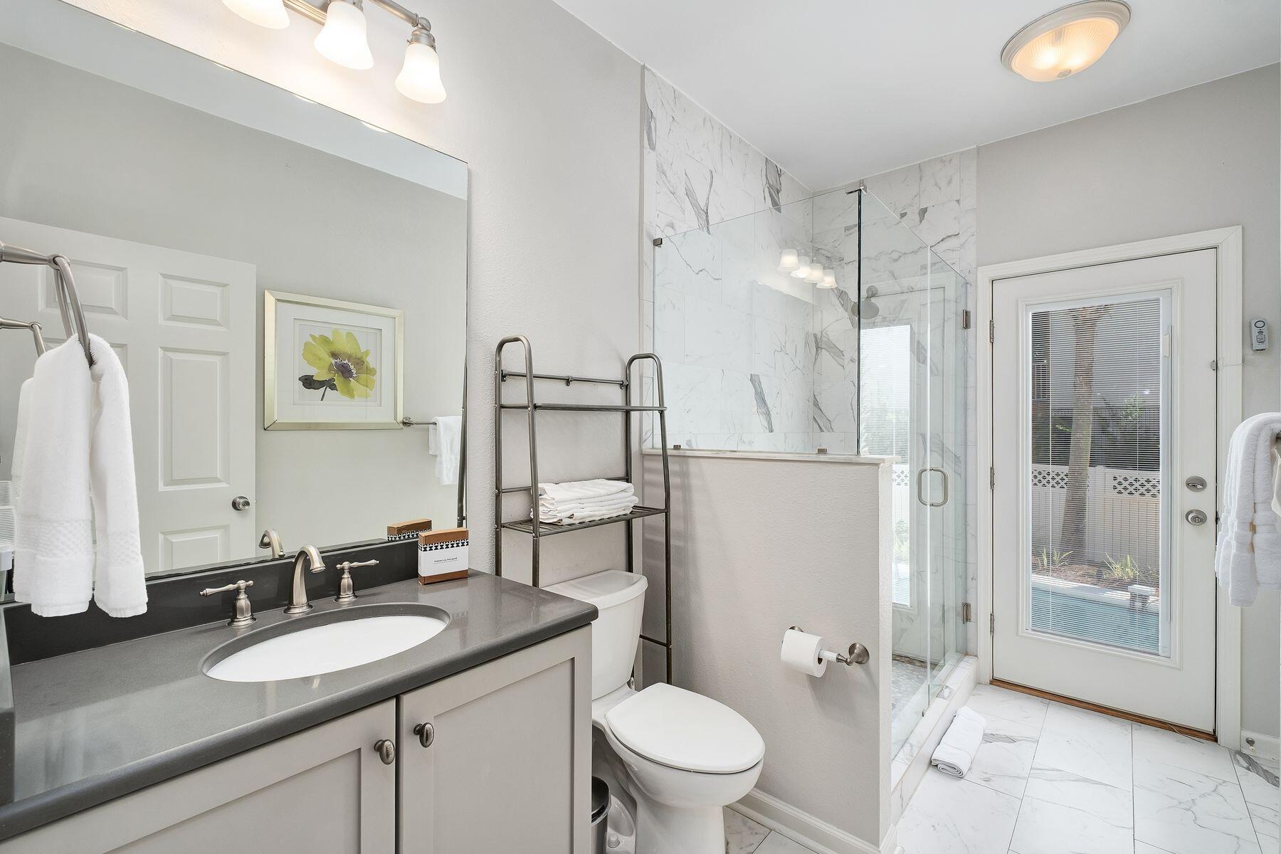 363 Pelican Circle Inlet Beach, FL 32461 - Photo 19 of 80 a bathroom with a granite countertop sink toilet a mirror a vanity and shower