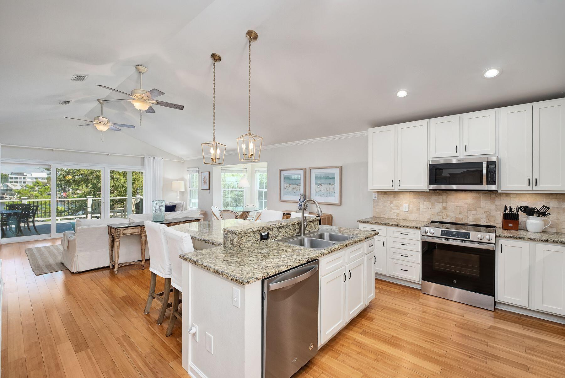 363 Pelican Circle Inlet Beach, FL 32461 - Photo 33 of 80 a large kitchen with kitchen island a stove a sink a center island and wooden floor