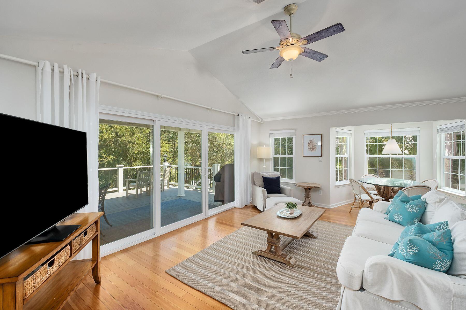 363 Pelican Circle Inlet Beach, FL 32461 - Photo 35 of 80 a living room with furniture a flat screen tv and a floor to ceiling window