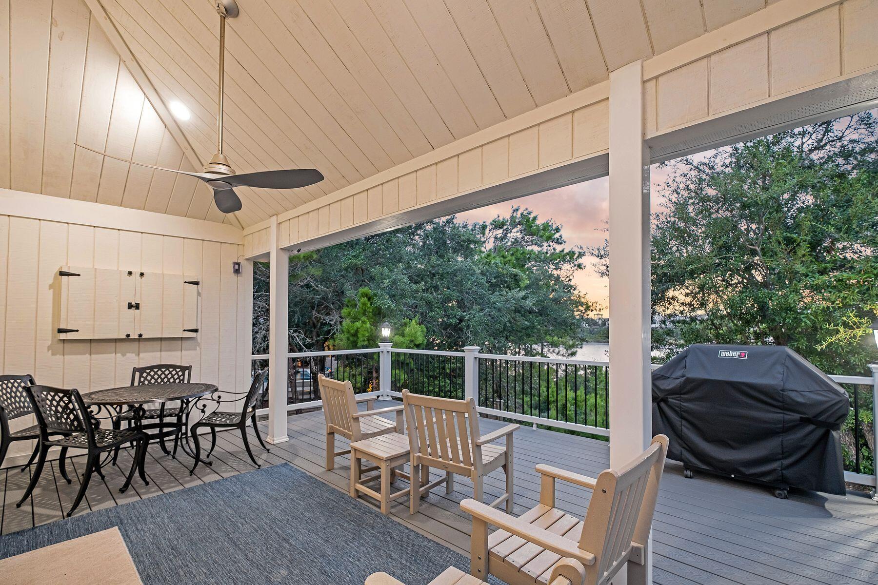 363 Pelican Circle Inlet Beach, FL 32461 - Photo 66 of 80 a view of a chairs and table in patio with wooden fence