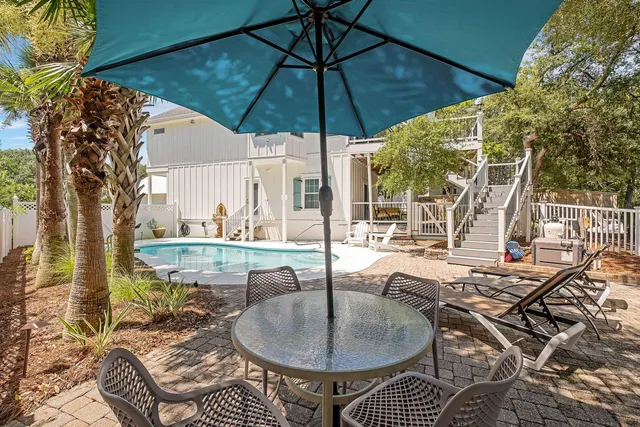 a bathroom with a granite countertop sink toilet a mirror a vanity and shower