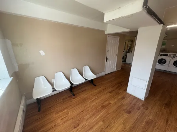 a view of entryway and hall with wooden floor