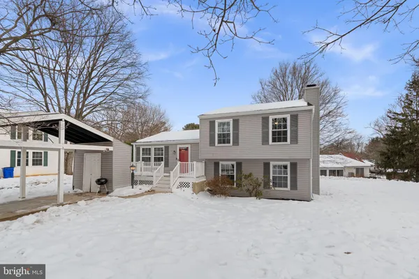 a view of a house with a yard covered in snow
