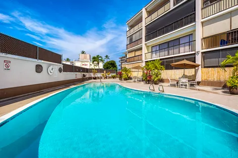 a swimming pool with outdoor seating and yard