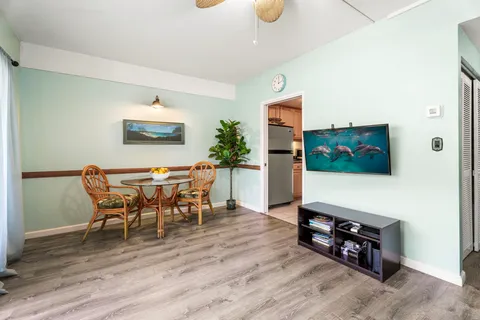 a dining room with furniture and wooden floor