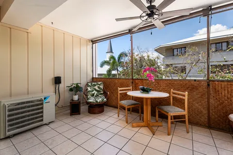 a dining room with furniture and a potted plant