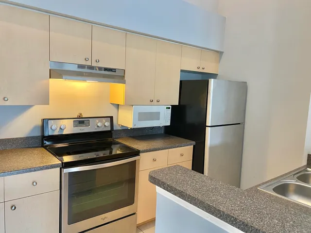 a kitchen with a sink a stove and refrigerator