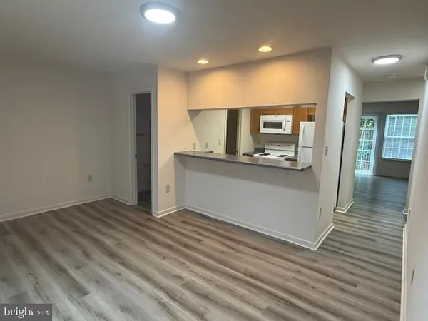 a view of a kitchen cabinets and a wooden floor