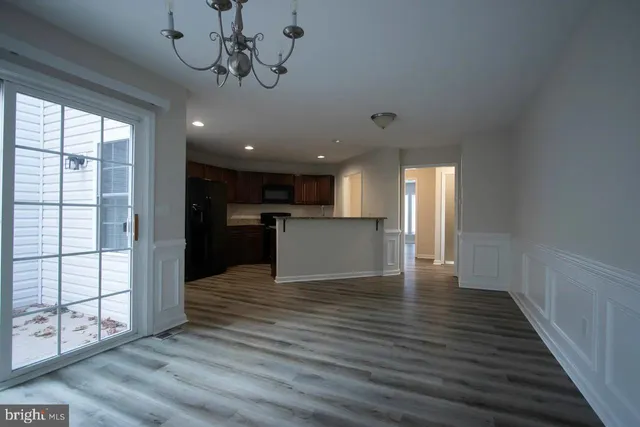 a view of a kitchen with a sink and wooden floor