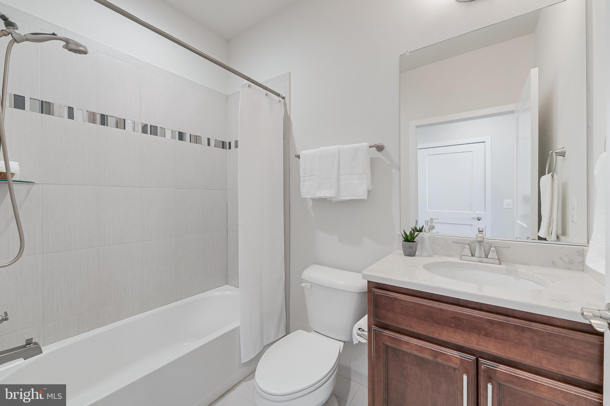 11695 Sunrise Square Place Reston, VA 20191 - Photo 12 of 72 a bathroom with a sink a toilet and shower