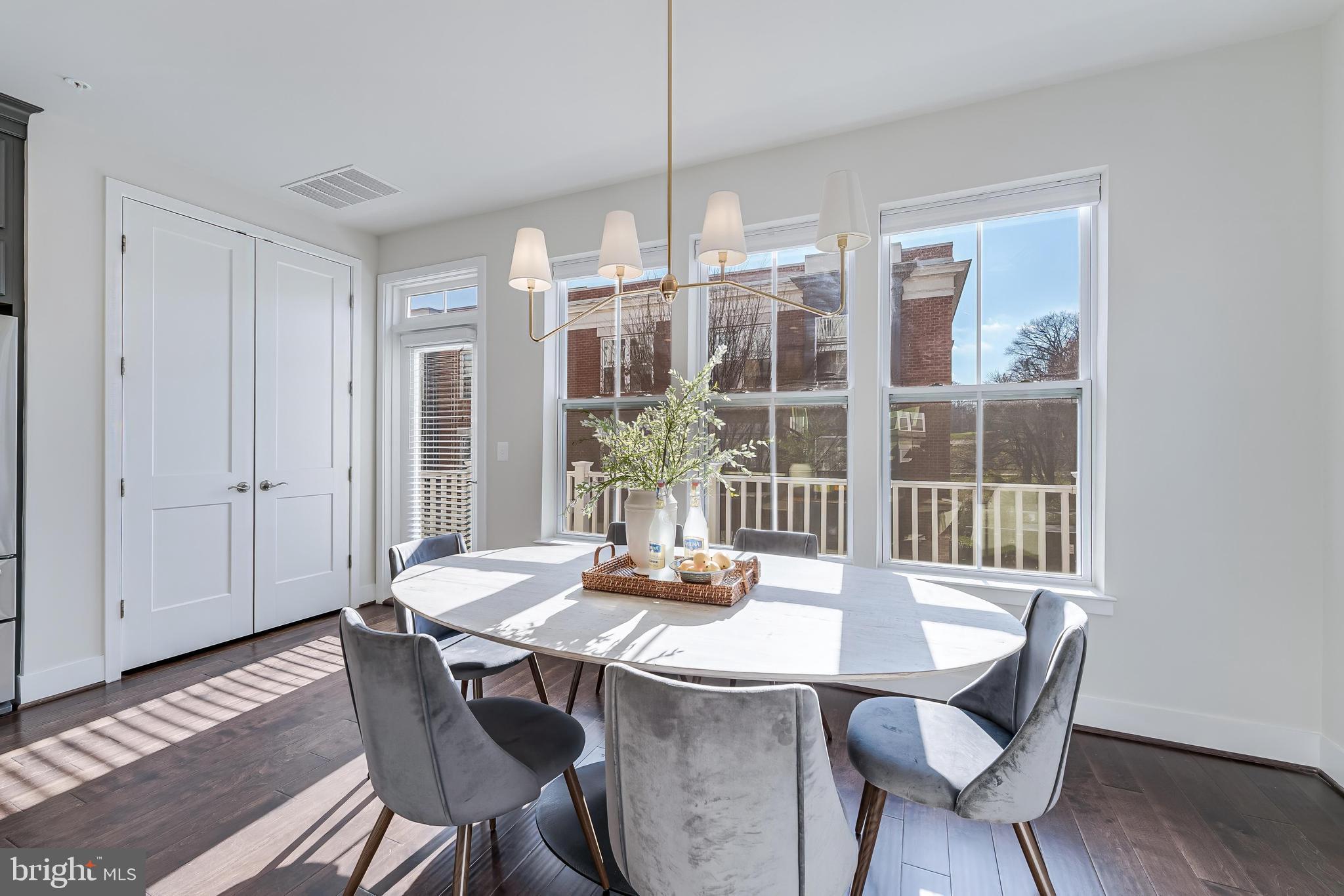 11695 Sunrise Square Place Reston, VA 20191 - Photo 25 of 72 a view of a dining room with furniture window and wooden floor