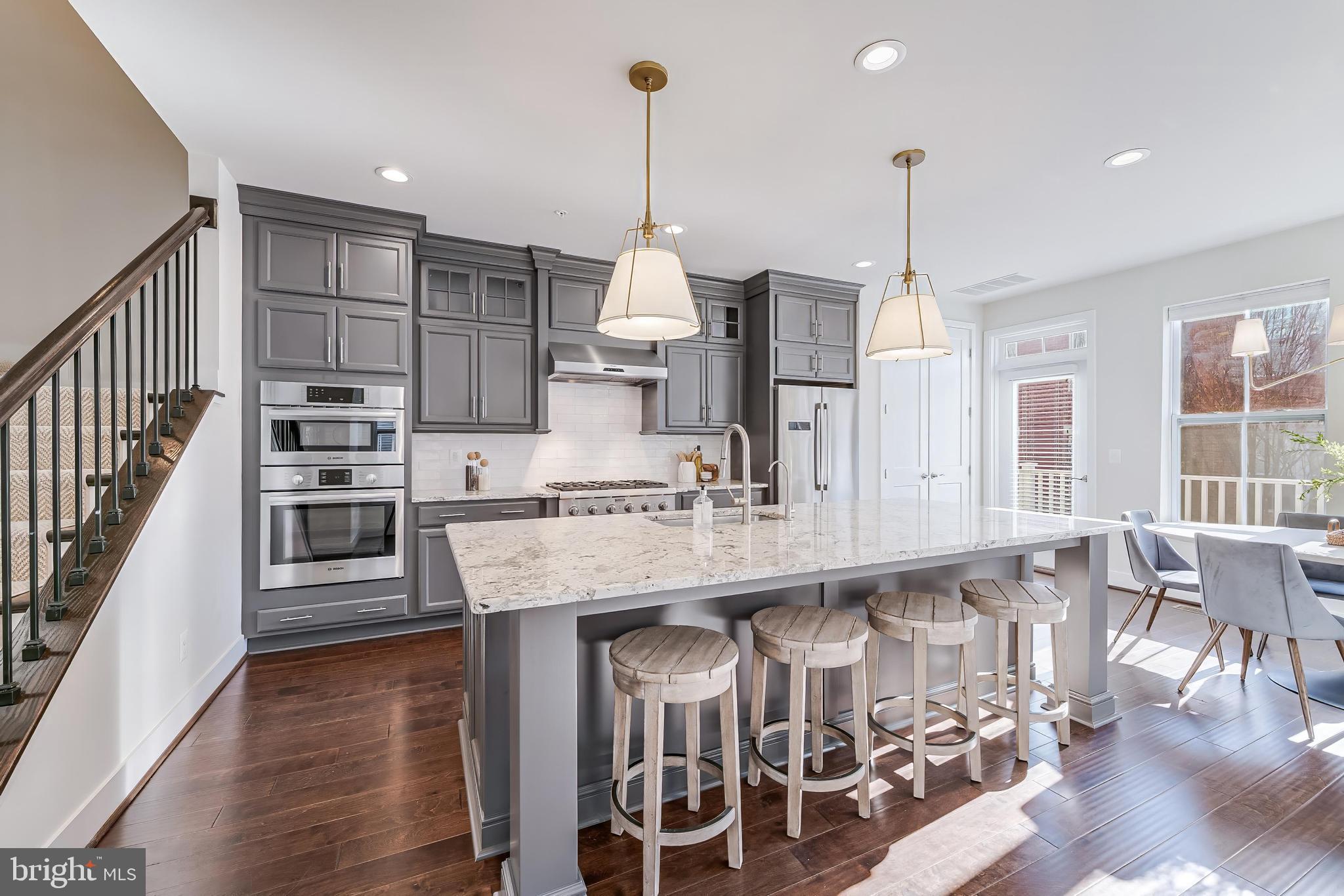 11695 Sunrise Square Place Reston, VA 20191 - Photo 28 of 72 a kitchen with stainless steel appliances granite countertop a stove and more cabinets