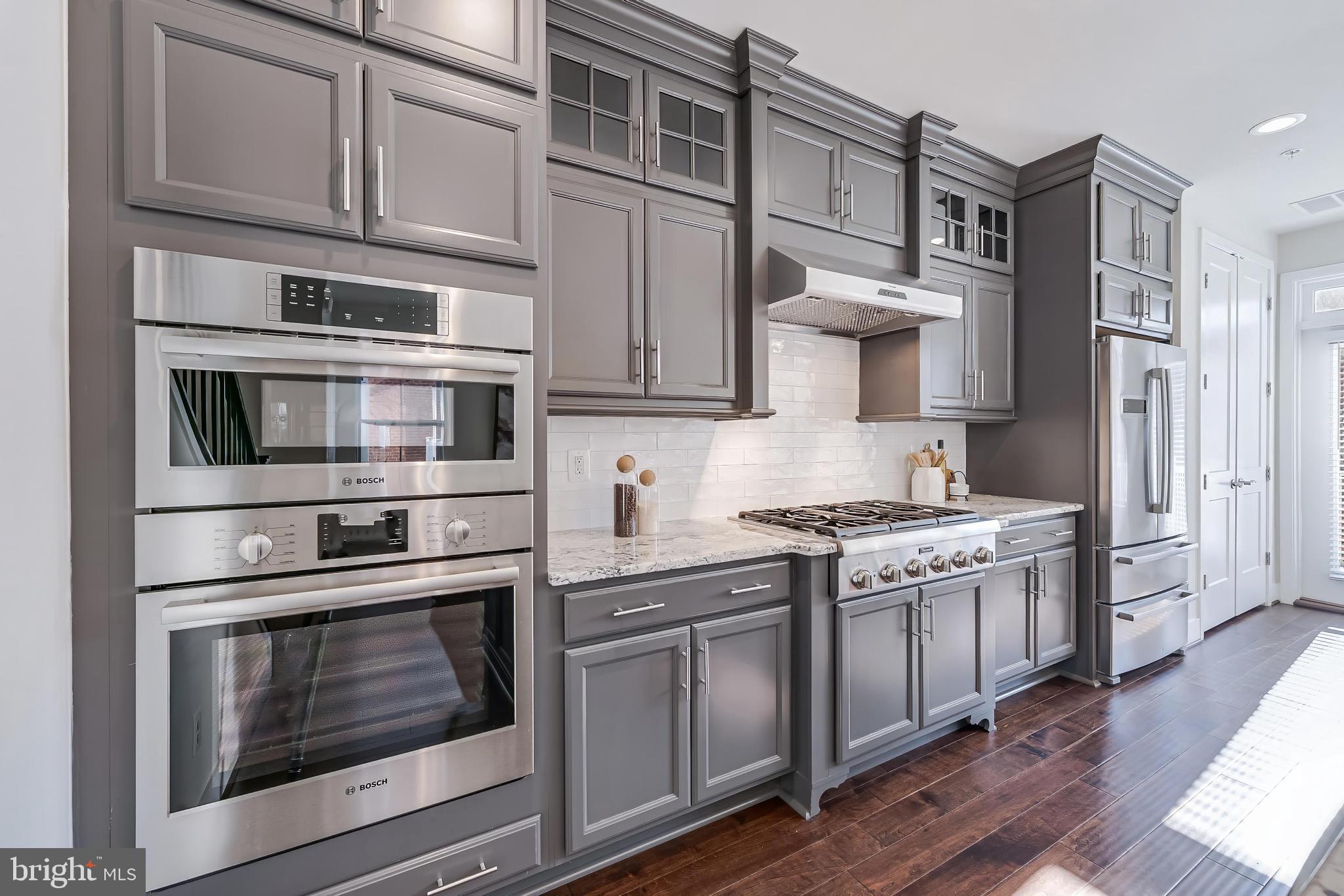 11695 Sunrise Square Place Reston, VA 20191 - Photo 30 of 72 a kitchen with stainless steel appliances granite countertop a stove and a microwave