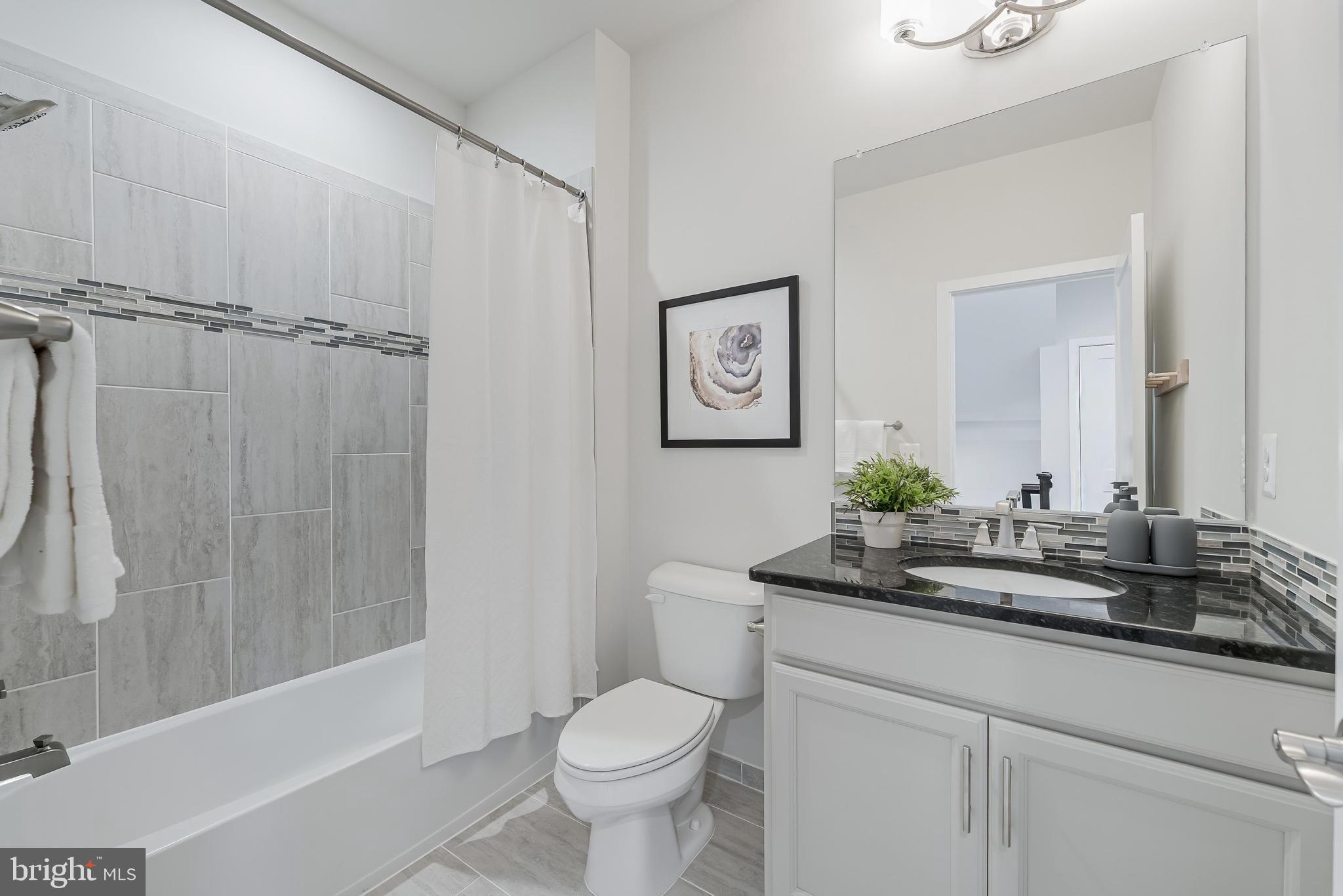 11695 Sunrise Square Place Reston, VA 20191 - Photo 35 of 72 a bathroom with a granite countertop sink toilet and shower