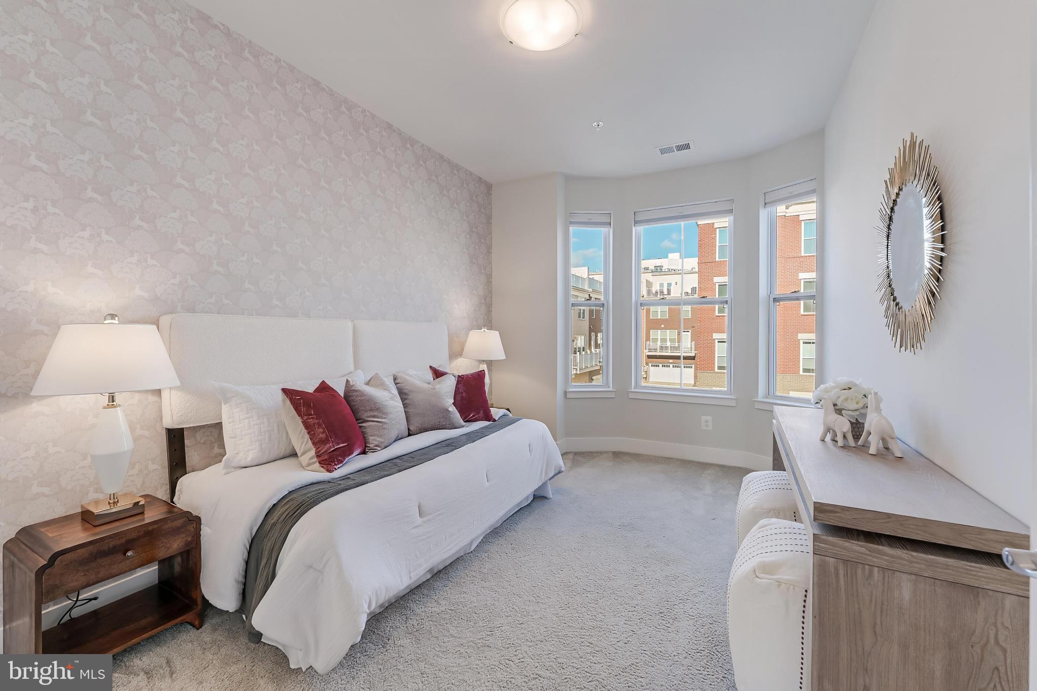 11695 Sunrise Square Place Reston, VA 20191 - Photo 36 of 72 a bed room with a bed and a lamp