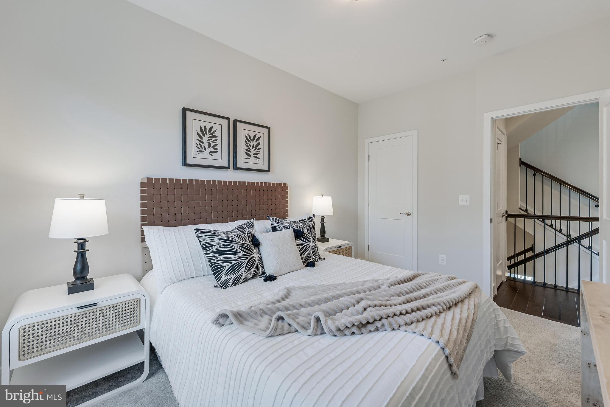 11695 Sunrise Square Place Reston, VA 20191 - Photo 40 of 72 a bedroom with a bed and a lamp