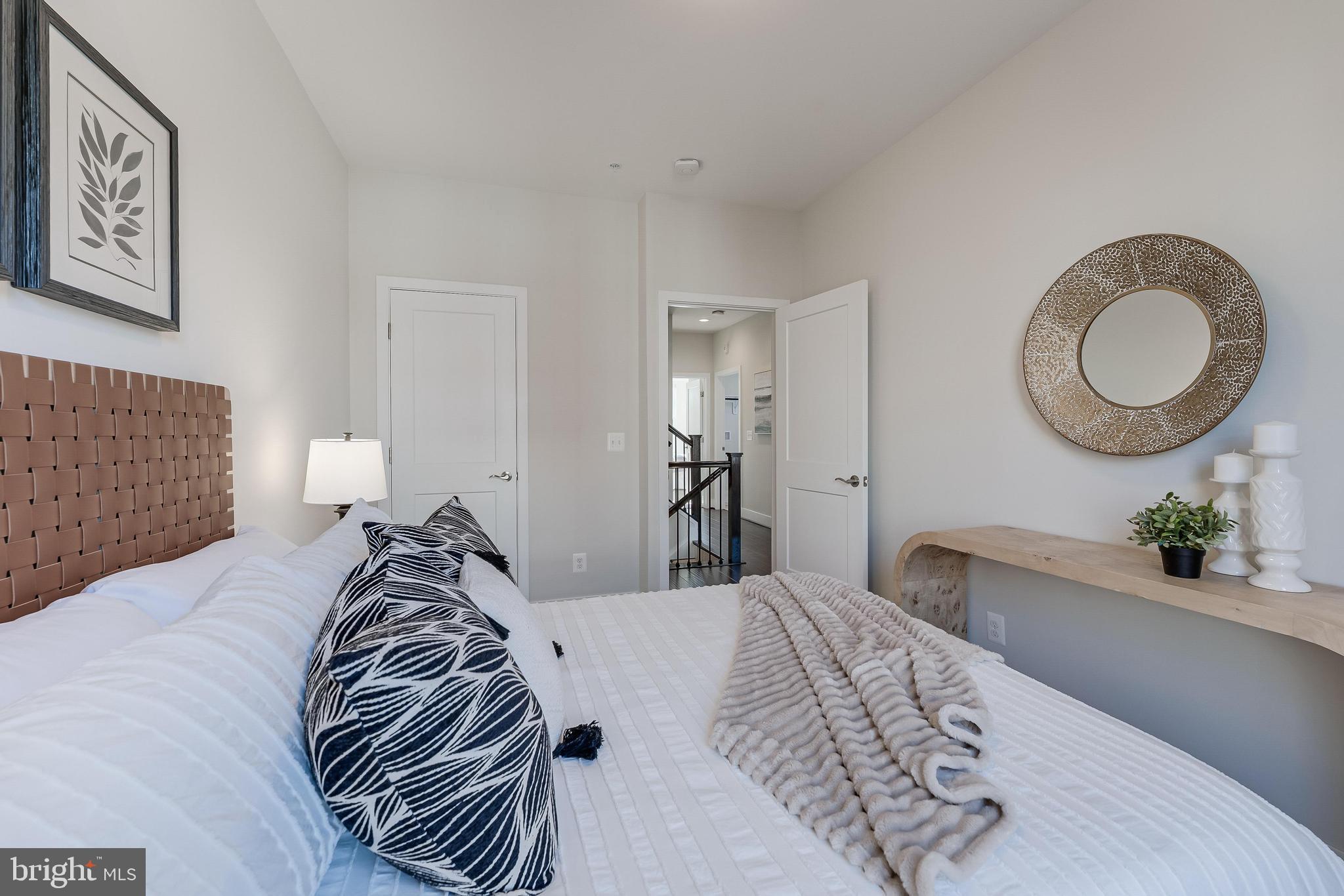 11695 Sunrise Square Place Reston, VA 20191 - Photo 41 of 72 a bedroom with a bed and lamp