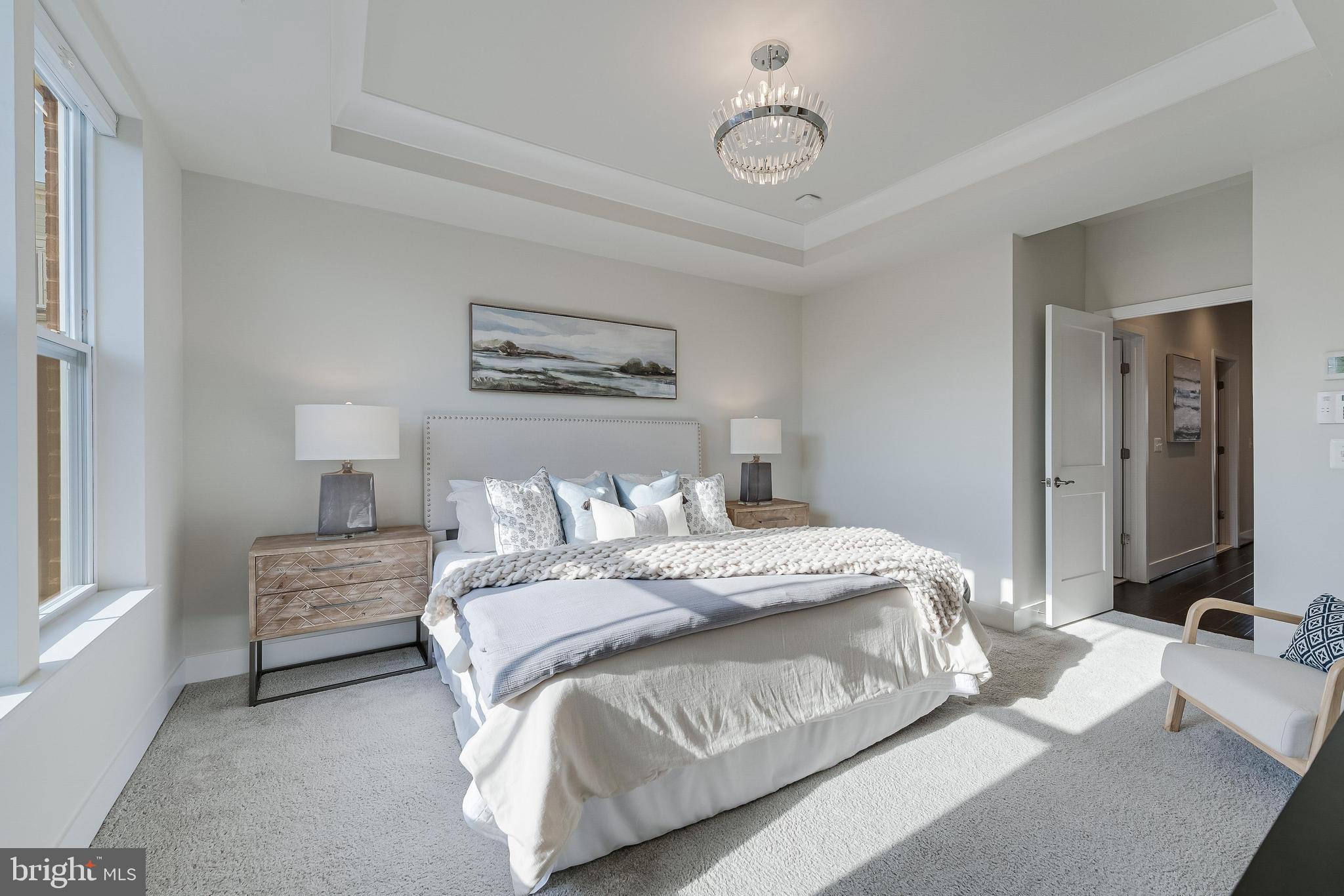 11695 Sunrise Square Place Reston, VA 20191 - Photo 43 of 72 a bedroom with a bed and a chandelier