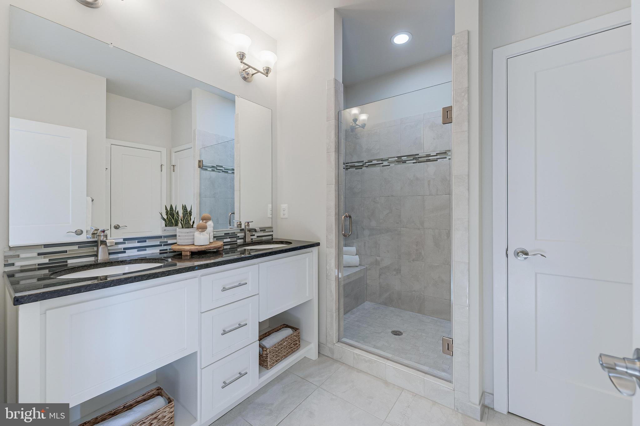 11695 Sunrise Square Place Reston, VA 20191 - Photo 48 of 72 a bathroom with a shower sink vanity granite and mirror