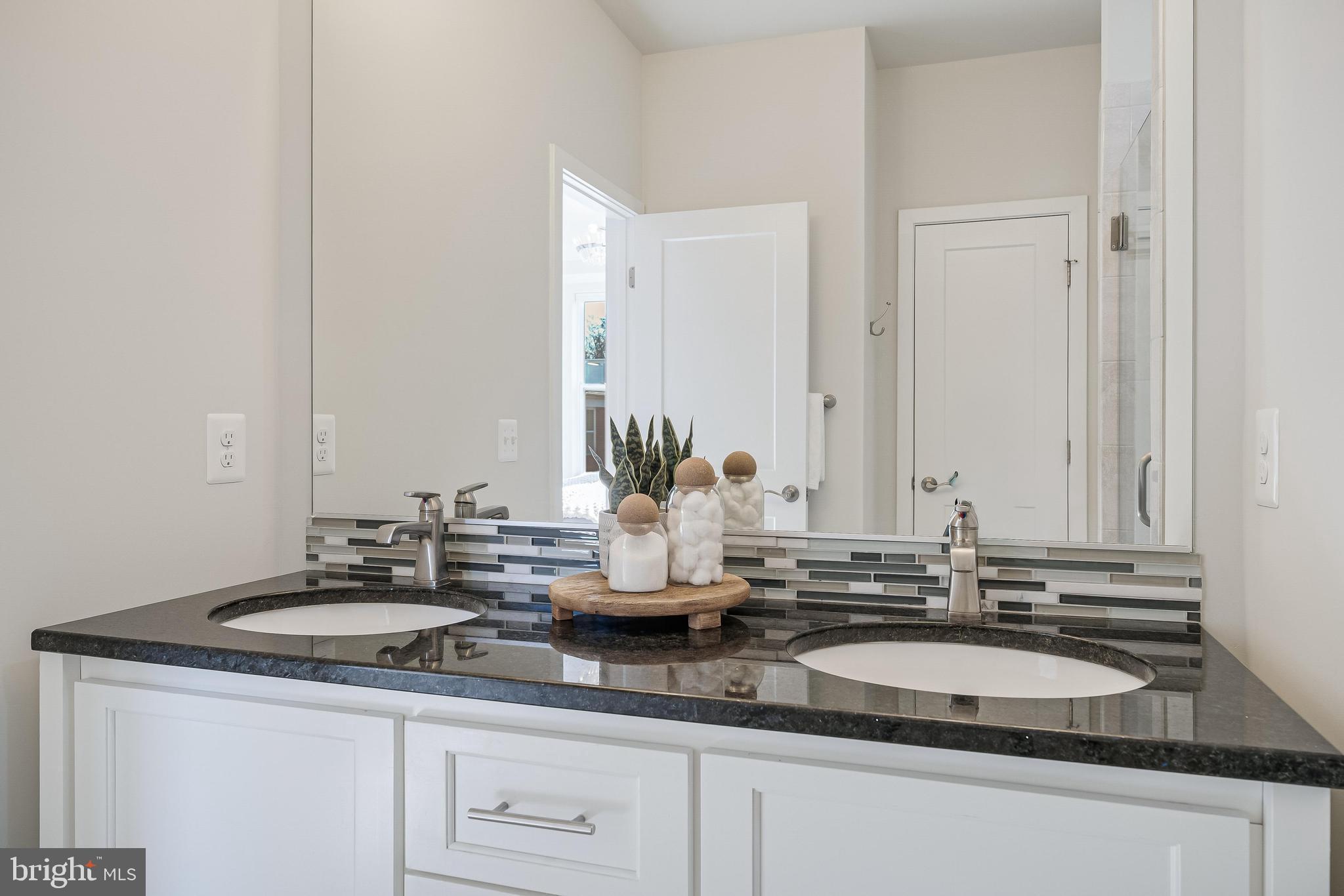 11695 Sunrise Square Place Reston, VA 20191 - Photo 49 of 72 a bathroom with a sink and a mirror