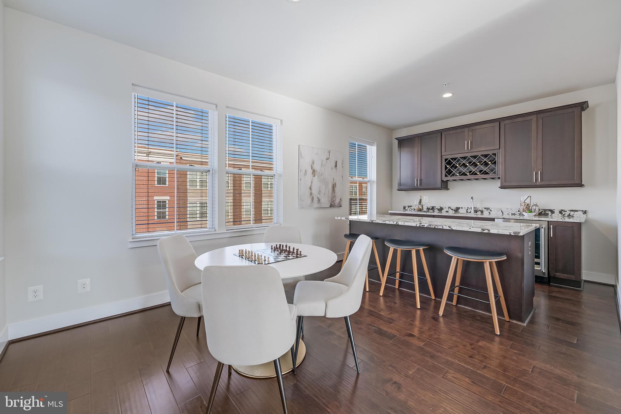 11695 Sunrise Square Place Reston, VA 20191 - Photo 55 of 72 a dining room with furniture window and wooden floor