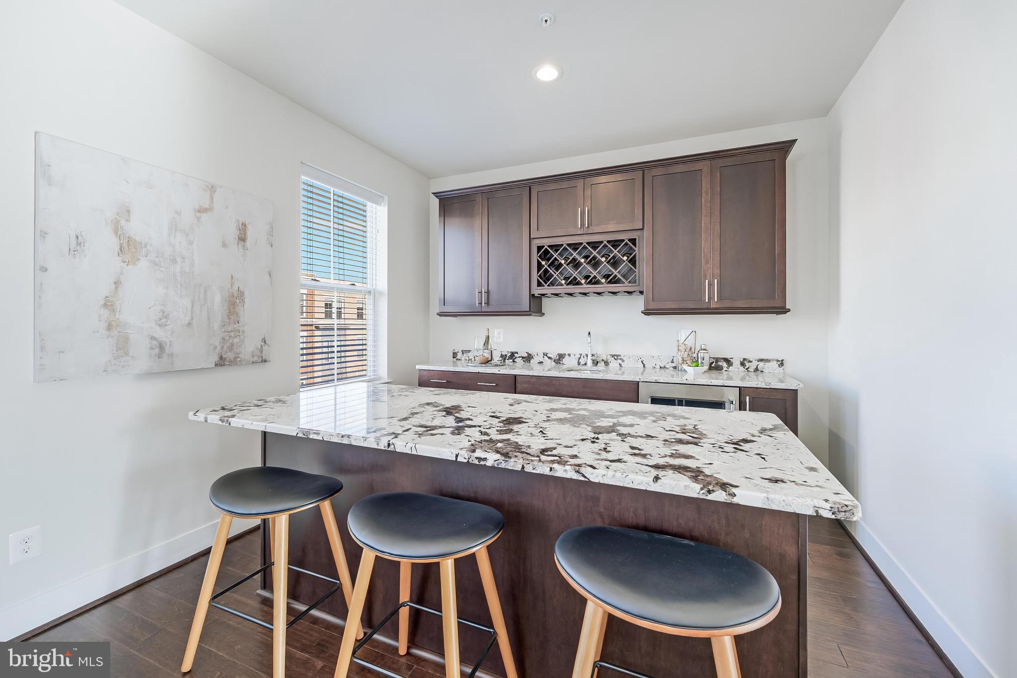 11695 Sunrise Square Place Reston, VA 20191 - Photo 56 of 72 a view of a kitchen area with furniture and wooden floor