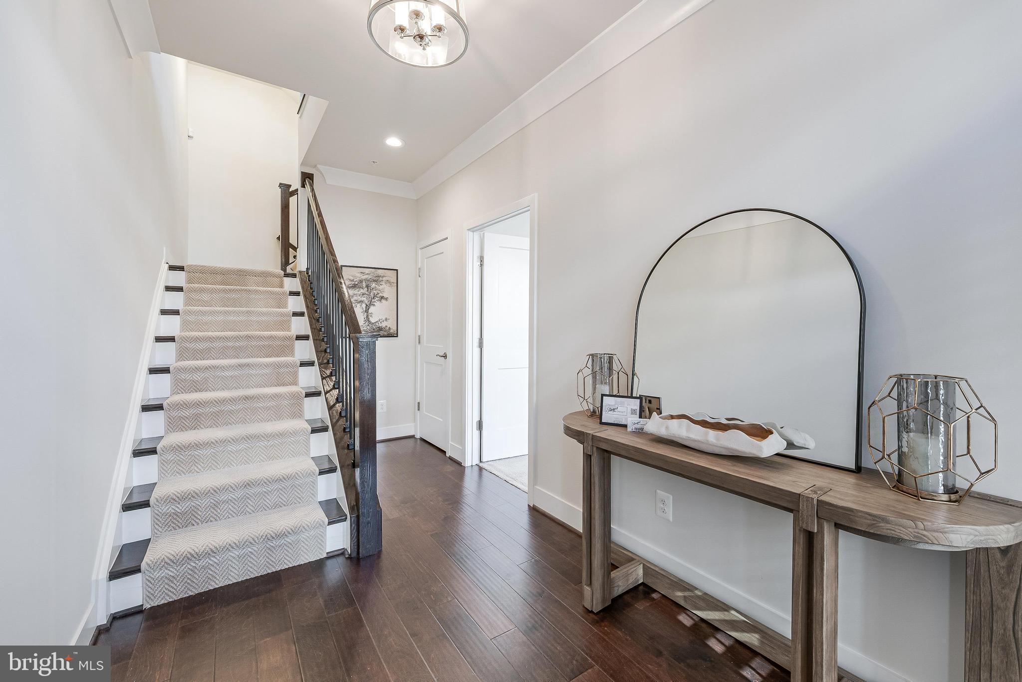 11695 Sunrise Square Place Reston, VA 20191 - Photo 7 of 72 a view of a room with wooden floor and stairs