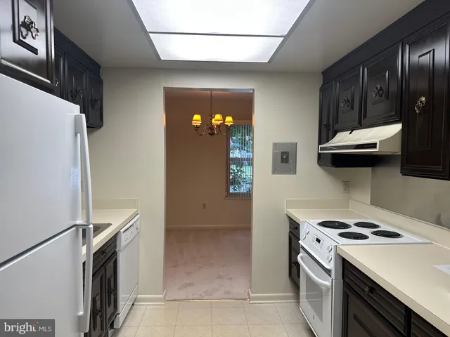 a kitchen with stainless steel appliances a stove a microwave and a refrigerator