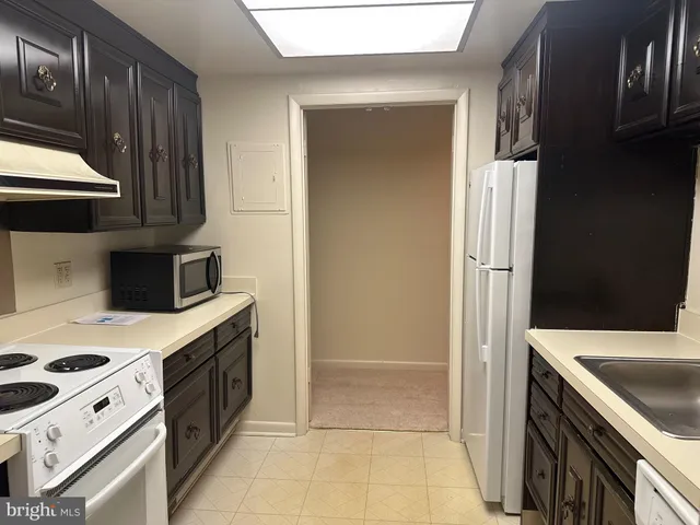 a kitchen with a stove and a refrigerator