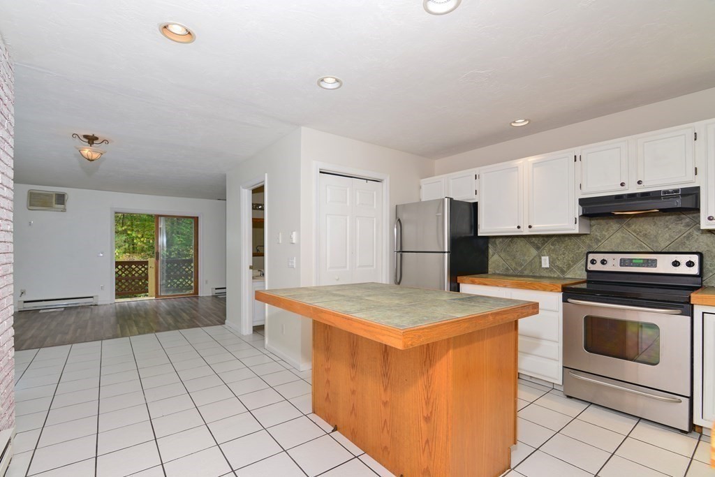 9 May Brook Road, Unit 9 Holland, MA 01521 - Photo 2 of 42 a kitchen with a stove a sink and a refrigerator