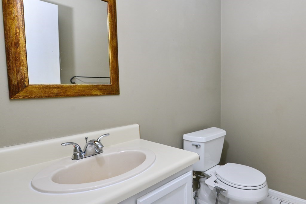 9 May Brook Road, Unit 9 Holland, MA 01521 - Photo 22 of 42 a bathroom with a toilet a sink and mirror