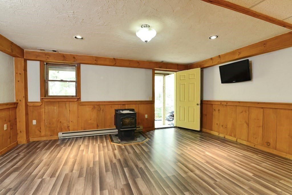 9 May Brook Road, Unit 9 Holland, MA 01521 - Photo 34 of 42 a view of empty room with wooden floor and fan