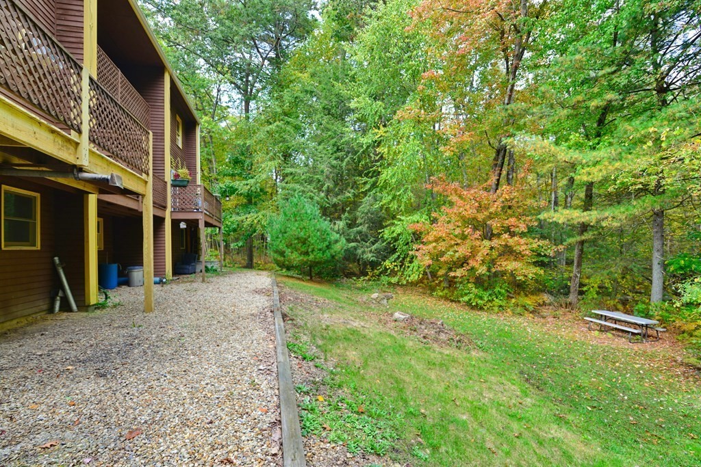 9 May Brook Road, Unit 9 Holland, MA 01521 - Photo 7 of 42 a view of a house with a backyard
